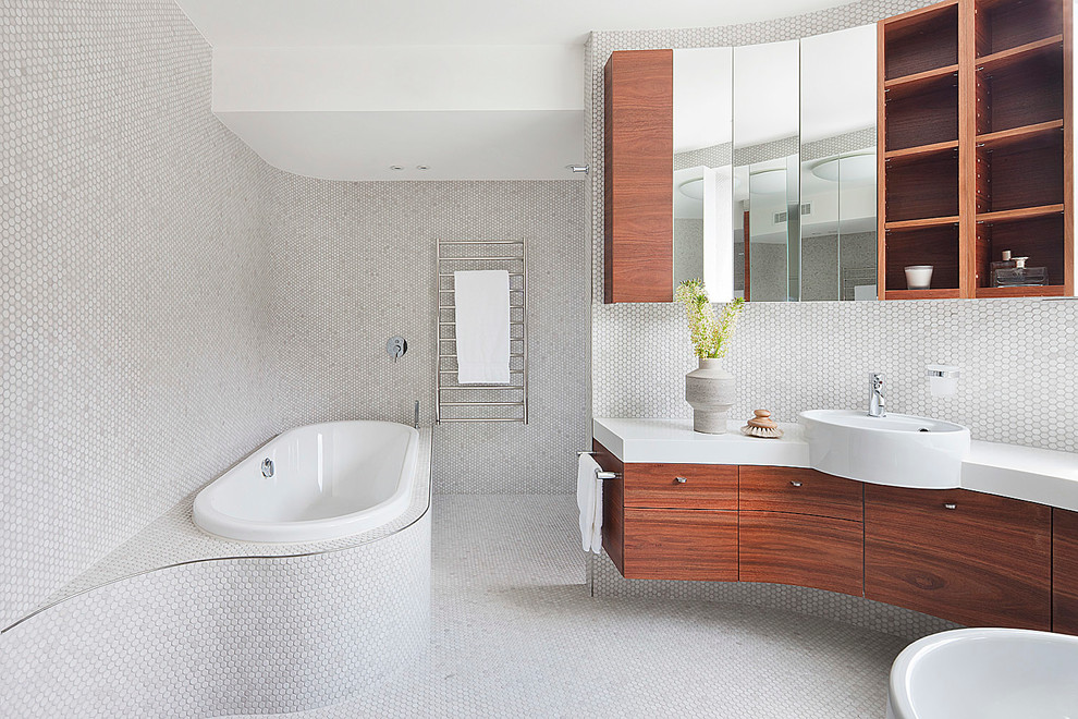 Design ideas for a large contemporary bathroom in Melbourne with medium wood cabinets, engineered quartz benchtops, a drop-in tub, white tile, mosaic tile and mosaic tile floors.