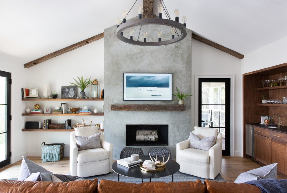 Inspiration for a mid-sized contemporary formal enclosed living room in Austin with white walls, medium hardwood floors, a standard fireplace, a concrete fireplace surround and a freestanding tv.