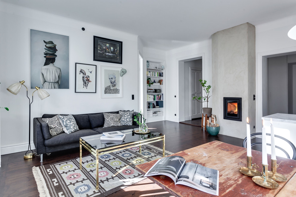 Design ideas for a mid-sized scandinavian formal open concept living room in Stockholm with white walls, dark hardwood floors, a standard fireplace, no tv and a metal fireplace surround.