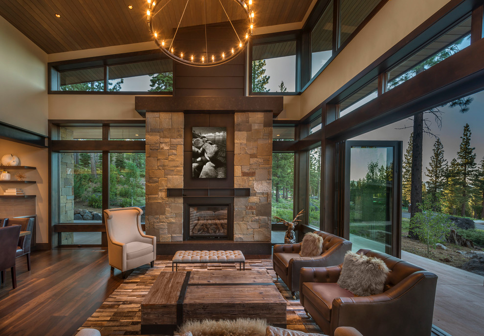 This is an example of a large country open concept living room in Sacramento with dark hardwood floors, a standard fireplace, a metal fireplace surround and brown floor.