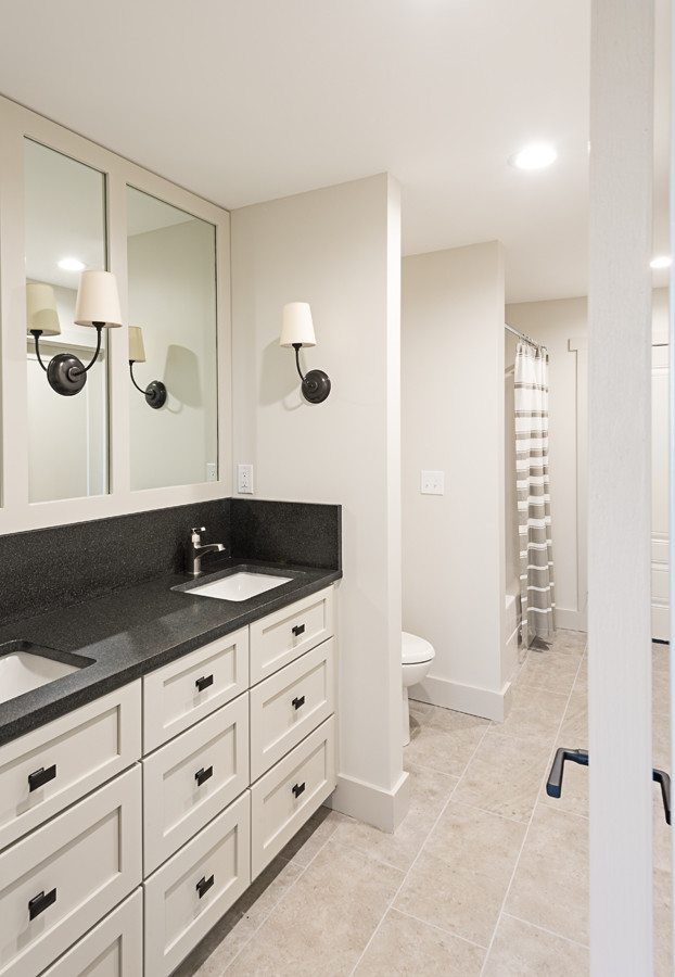 Mid-sized transitional 3/4 ceramic tile and black floor alcove bathtub photo with shaker cabinets, beige cabinets, a two-piece toilet, beige walls, an undermount sink and granite countertops