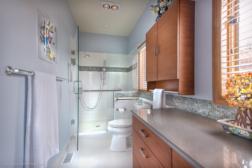 Inspiration for a mid-sized contemporary master bathroom in Denver with flat-panel cabinets, medium wood cabinets, an alcove shower, a two-piece toilet, multi-coloured tile, glass tile and purple walls.