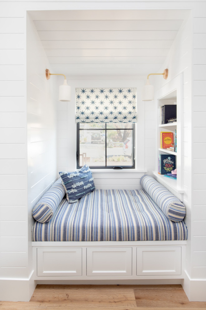 Small country gender neutral kids' bedroom in Orange County with white walls, light hardwood flooring, brown floors, a timber clad ceiling, tongue and groove walls and feature lighting.