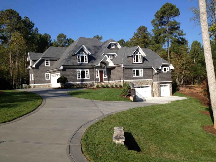 Huge elegant gray split-level mixed siding house exterior photo in Raleigh with a hip roof and a shingle roof