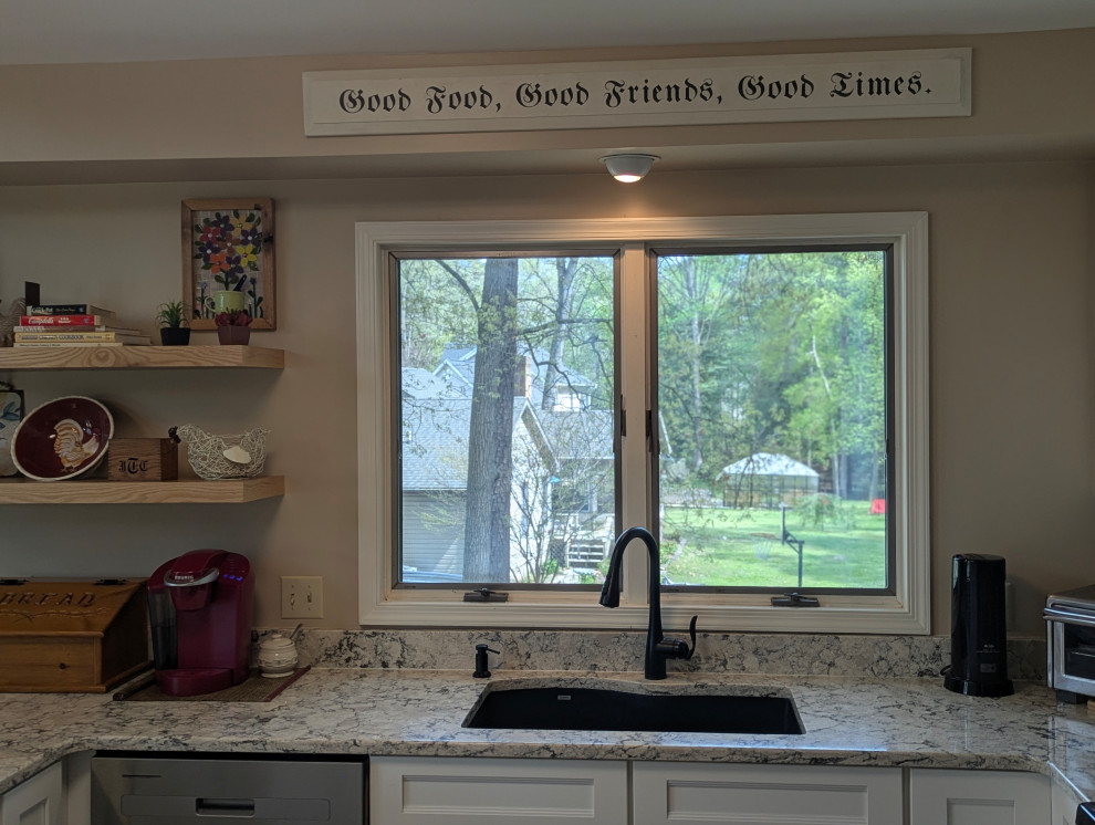 Example of a small transitional u-shaped eat-in kitchen design with flat-panel cabinets
