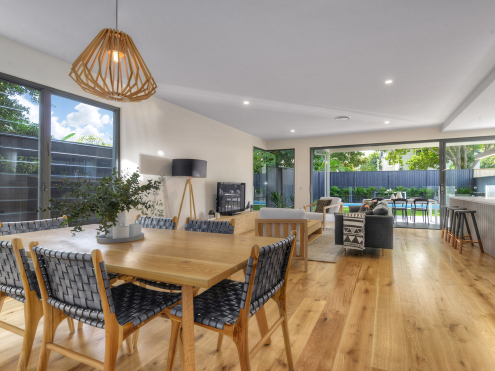 Design ideas for a transitional open plan dining in Brisbane with white walls and carpet.