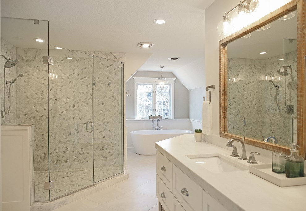 Mid-sized transitional master marble tile porcelain tile and white floor freestanding bathtub photo with shaker cabinets, white cabinets, an undermount sink and marble countertops