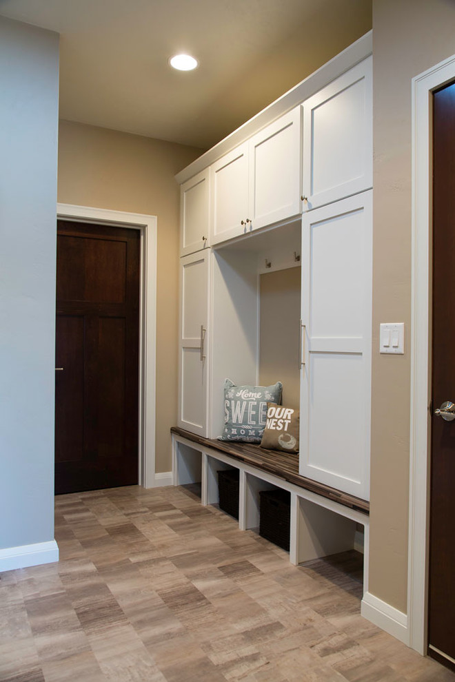 Mid-sized transitional brown floor entry hall photo with beige walls