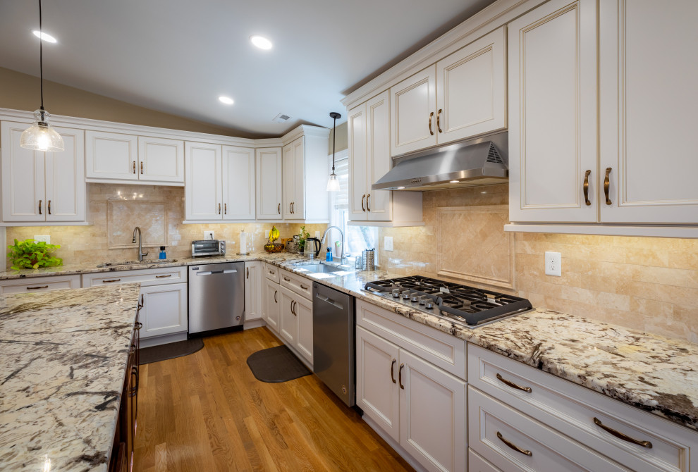 Large transitional u-shaped kitchen in Richmond with an undermount sink, shaker cabinets, granite benchtops, stainless steel appliances, medium hardwood floors and with island.