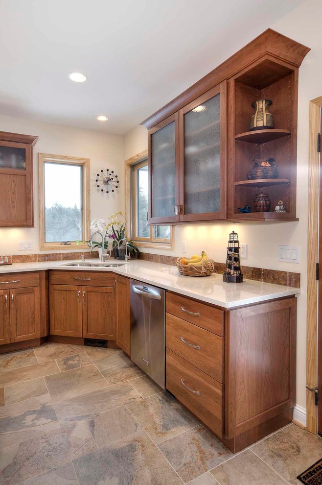 Mid-sized transitional u-shaped slate floor kitchen photo with an undermount sink, flat-panel cabinets, medium tone wood cabinets, quartz countertops, brown backsplash, stone tile backsplash, stainless steel appliances and an island