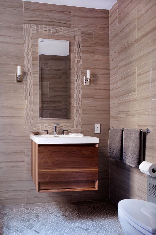 Design ideas for a contemporary powder room in New York with flat-panel cabinets, beige tile, gray tile, porcelain tile, mosaic tile floors, an integrated sink, medium wood cabinets and grey floor.