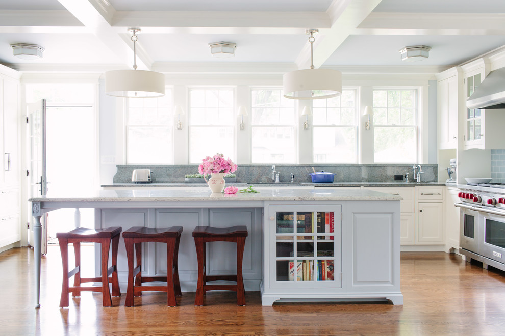 Open concept kitchen - large traditional l-shaped medium tone wood floor open concept kitchen idea in Chicago with an island, an undermount sink, shaker cabinets, white cabinets, granite countertops, blue backsplash, subway tile backsplash and stainless steel appliances