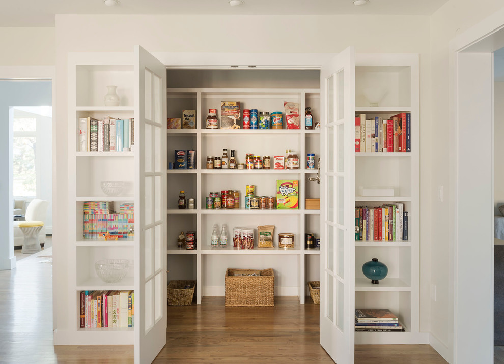 Photo of a mid-sized transitional kitchen pantry in New York with medium hardwood floors.