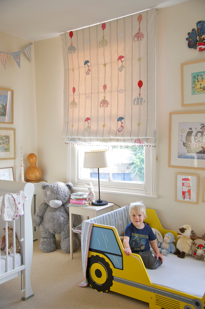 Design ideas for a medium sized farmhouse gender neutral kids' bedroom in Wiltshire with beige walls and carpet.