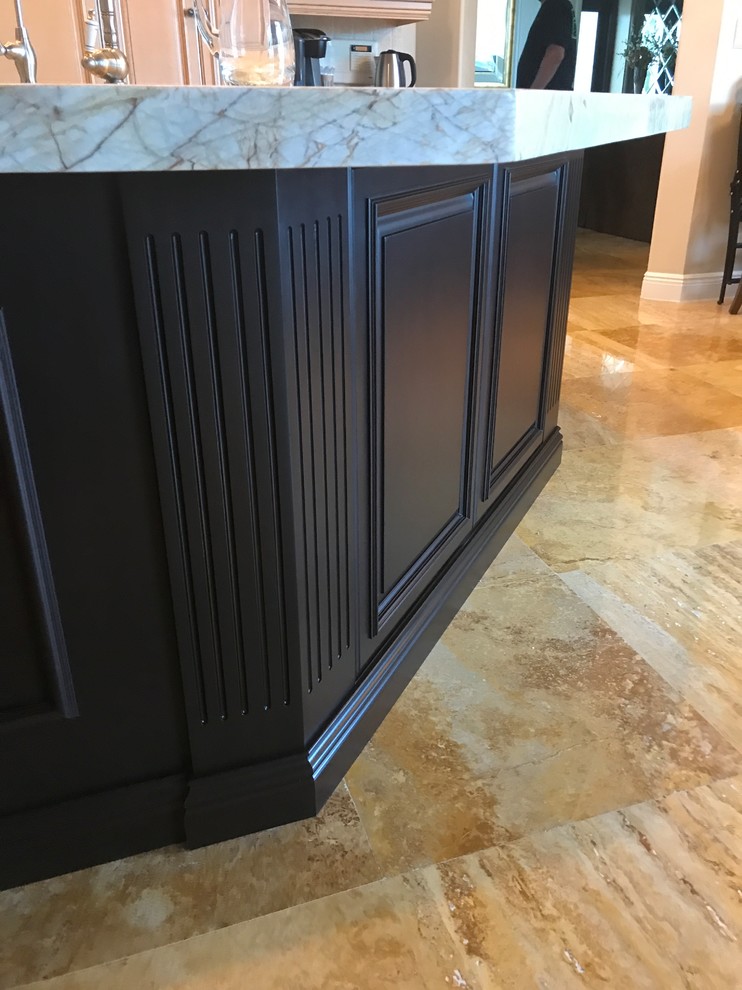 Example of a mid-sized transitional brown floor kitchen design in Miami with an undermount sink, paneled appliances and an island