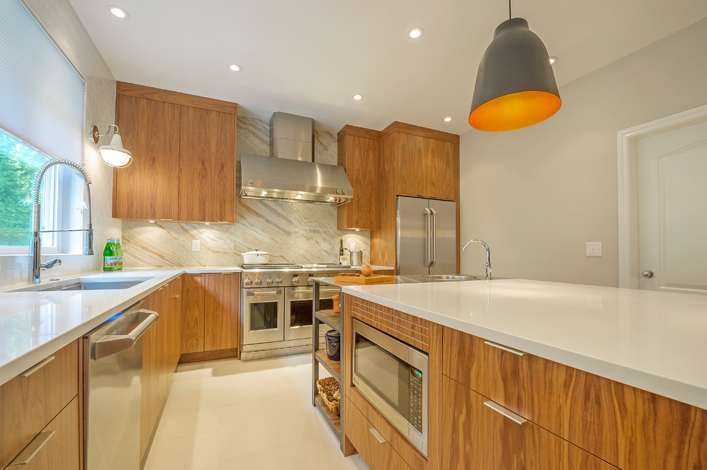 This is an example of a large contemporary l-shaped eat-in kitchen in Vancouver with a single-bowl sink, flat-panel cabinets, medium wood cabinets, quartzite benchtops, beige splashback, stone slab splashback, stainless steel appliances, ceramic floors and with island.
