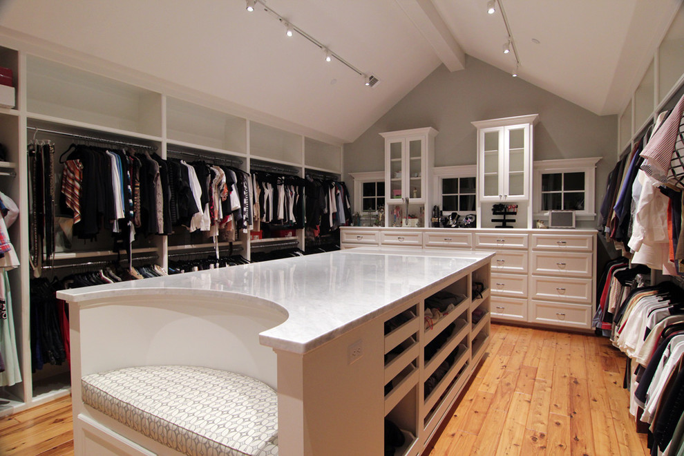 Design ideas for a traditional walk-in wardrobe in Houston with white cabinets.