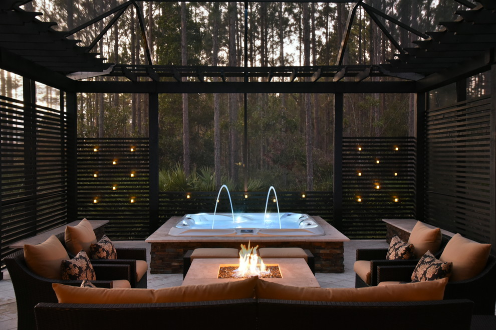Inspiration for a mid-sized tropical backyard patio in Jacksonville with a pergola, a fire feature and tile.