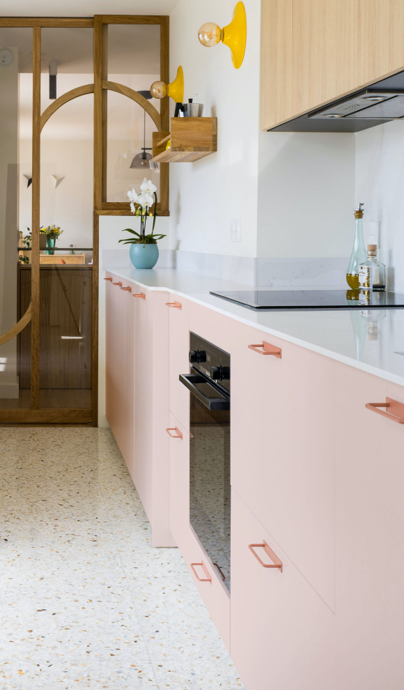 Design ideas for a mid-sized contemporary single-wall separate kitchen in Paris with quartzite benchtops, white splashback, engineered quartz splashback, black appliances, terrazzo floors, multi-coloured floor and white benchtop.