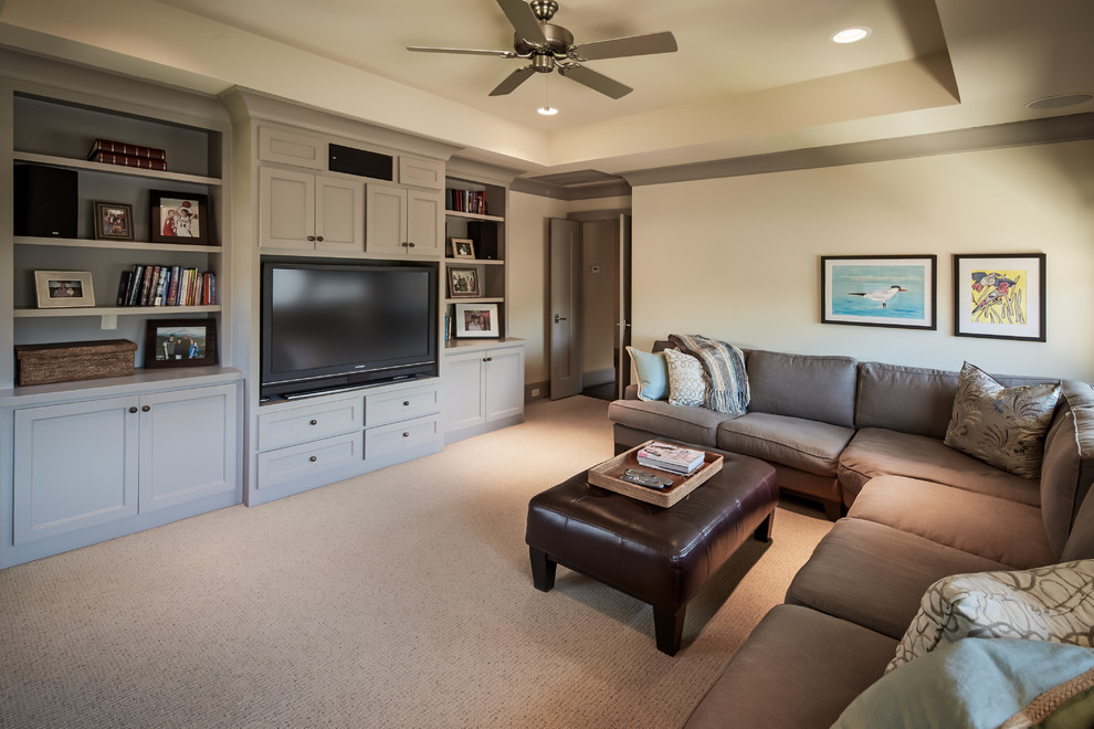 Photo of a mid-sized traditional enclosed family room in Houston with beige walls, carpet, a built-in media wall and no fireplace.
