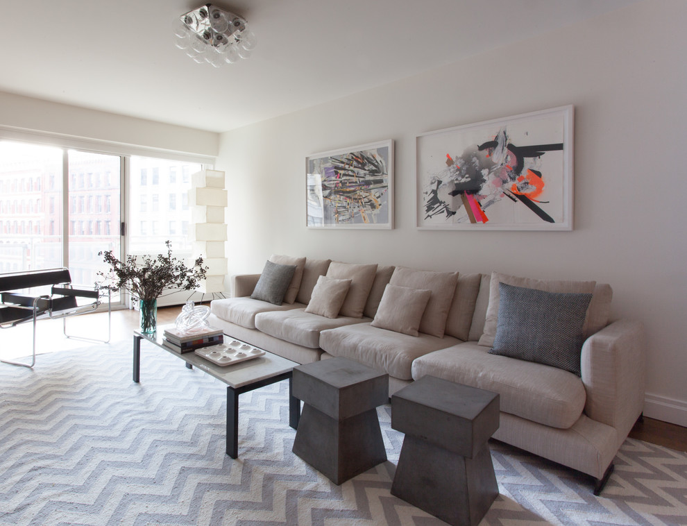 Inspiration for a mid-sized contemporary formal and open concept medium tone wood floor and brown floor living room remodel in New York with white walls, no fireplace and a wall-mounted tv