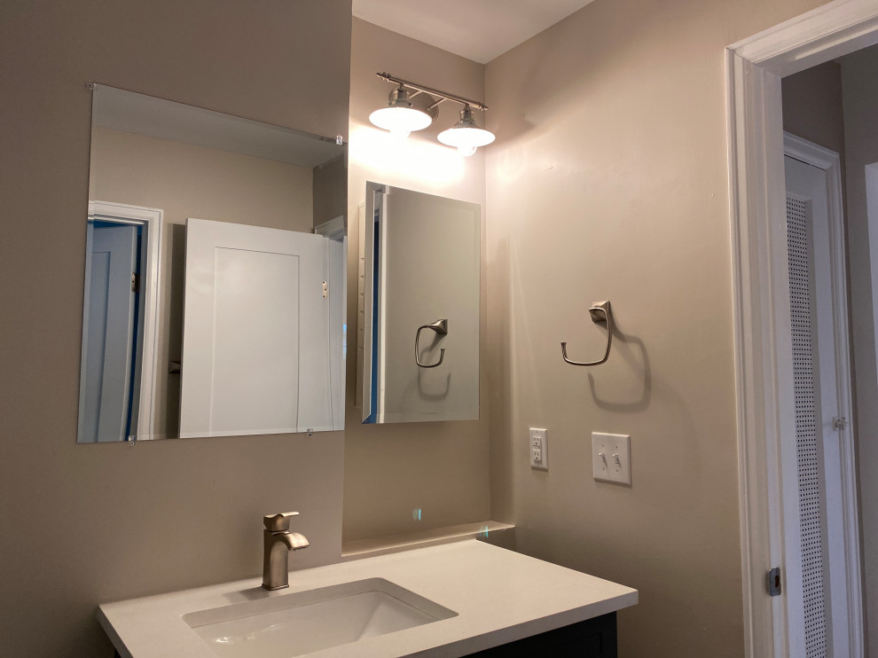 Mid-sized contemporary master bathroom in Denver with shaker cabinets, brown cabinets, a one-piece toilet, beige tile, ceramic tile, beige walls, ceramic floors, an undermount sink, quartzite benchtops, grey floor, a sliding shower screen, beige benchtops, a single vanity, a freestanding vanity and coffered.