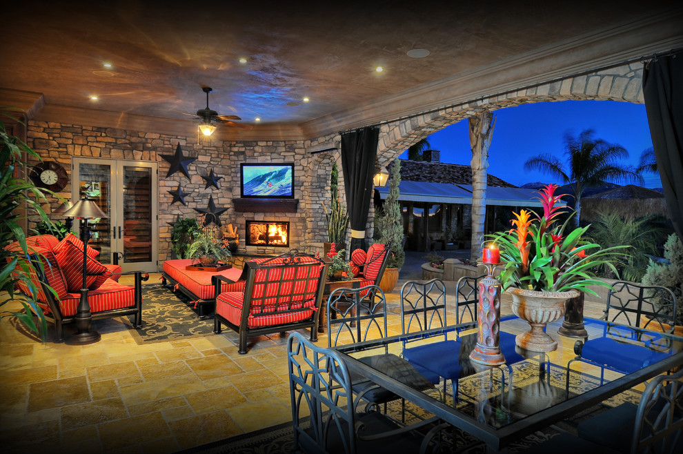 Example of a tuscan patio design in San Diego with a roof extension
