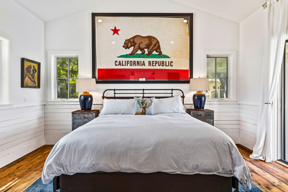 Photo of a country guest bedroom in San Francisco with white walls and medium hardwood floors.