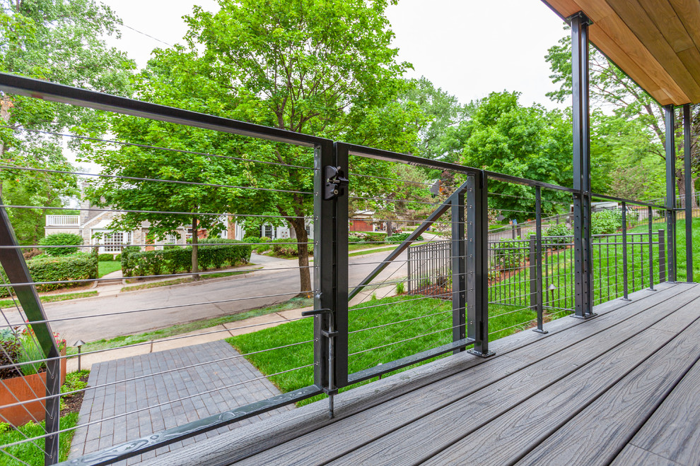 Photo of a mid-sized modern front yard verandah in Minneapolis with decking and a roof extension.