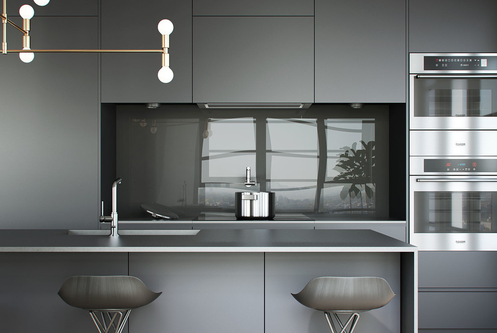 Photo of a large modern open plan kitchen in Montreal with an undermount sink, flat-panel cabinets, grey cabinets, laminate benchtops, black splashback, glass tile splashback, light hardwood floors and with island.
