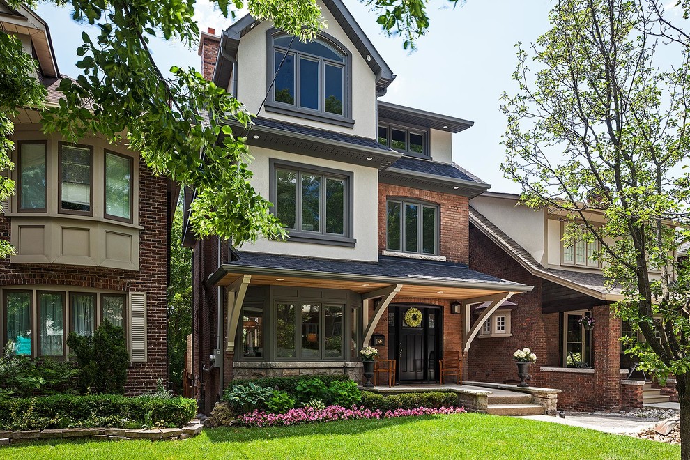 Design ideas for a large traditional three-storey brick exterior in Toronto.