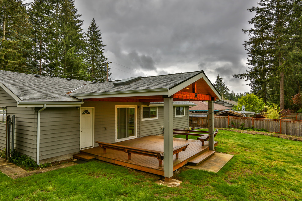 Inspiration for a mid-sized modern backyard patio remodel in Seattle with decking and a roof extension