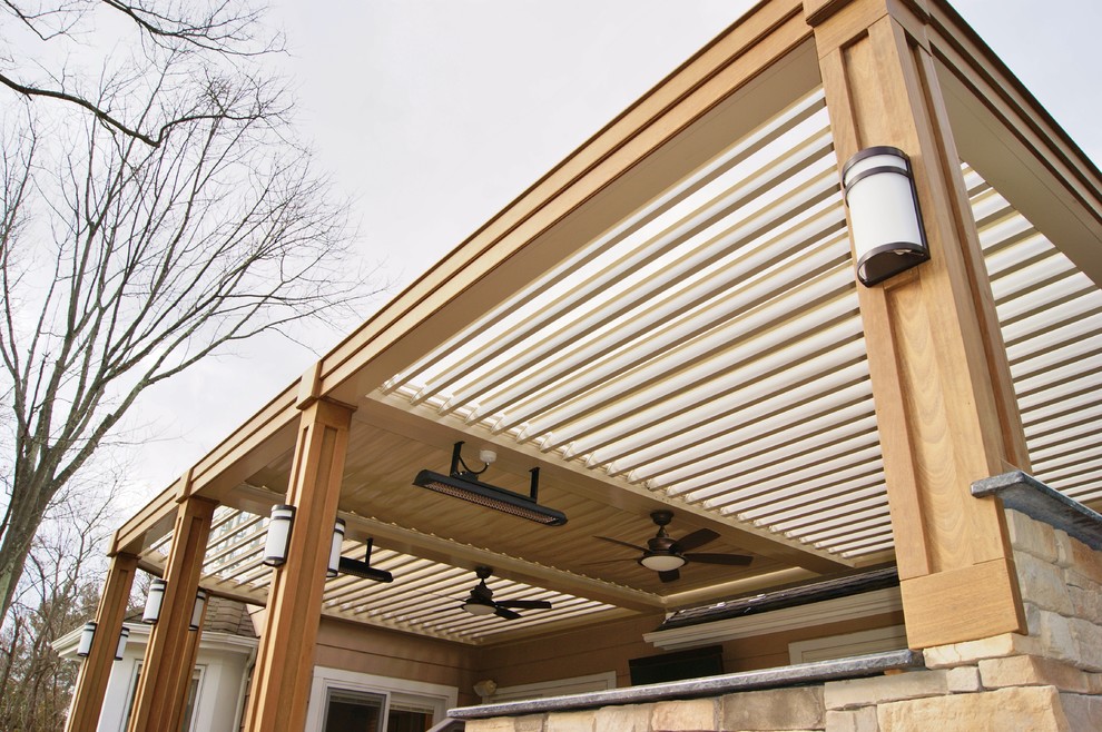 This is an example of a contemporary backyard deck in New York with a pergola.