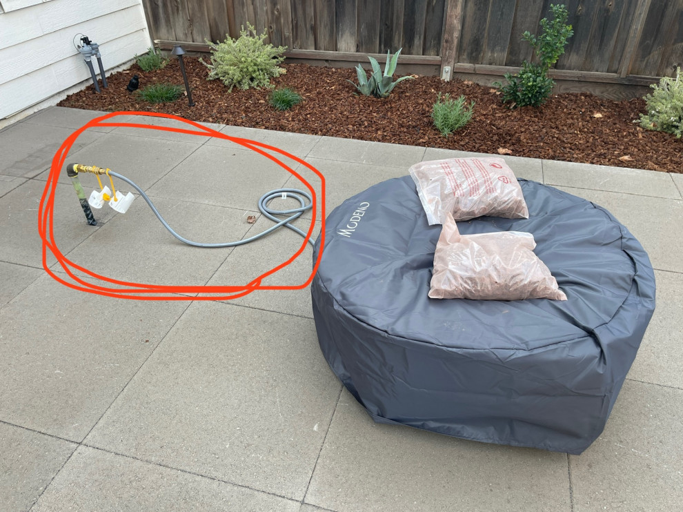Natural gas fire pit how to hide gas pipe while adhering to CA code?