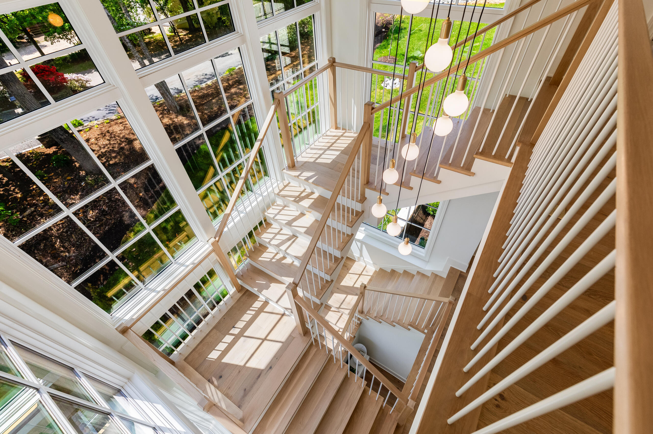 Project #152 | Three-Story White Oak Staircase with a Pendant Chandelier