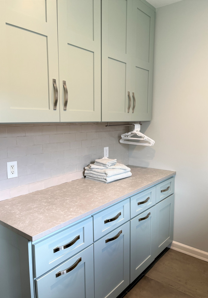Large galley dedicated laundry room in Detroit with an undermount sink, shaker cabinets, turquoise cabinets, quartz benchtops, white splashback, subway tile splashback, white walls, porcelain floors, a side-by-side washer and dryer, grey floor and grey benchtop.