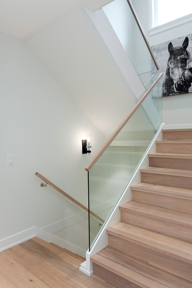 Photo of a contemporary wood u-shaped staircase in Vancouver with wood risers.