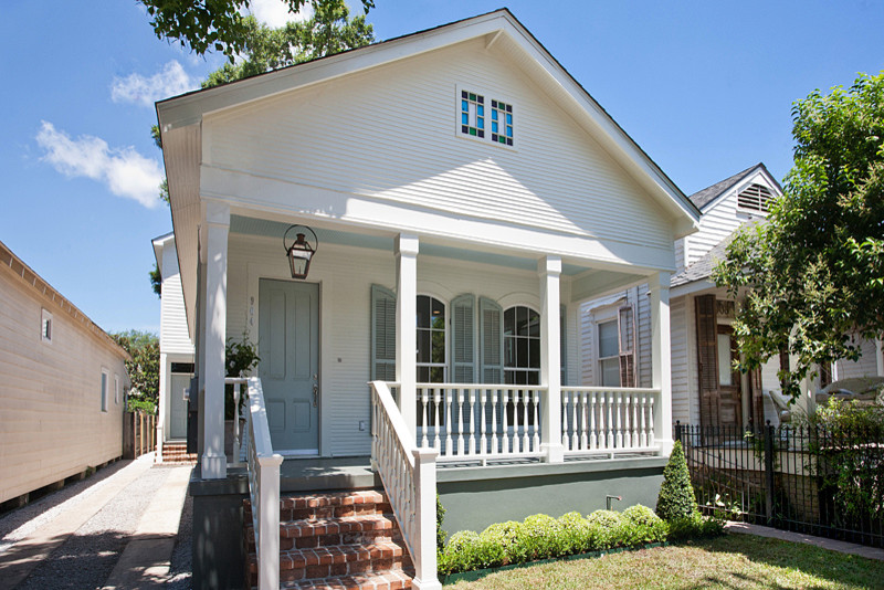 This is an example of a traditional one-storey white exterior in New Orleans with wood siding and a gable roof.