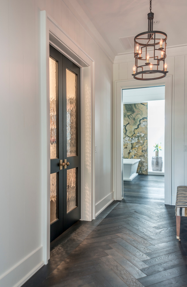 Photo of a large transitional hallway in Charleston with white walls, dark hardwood floors and grey floor.