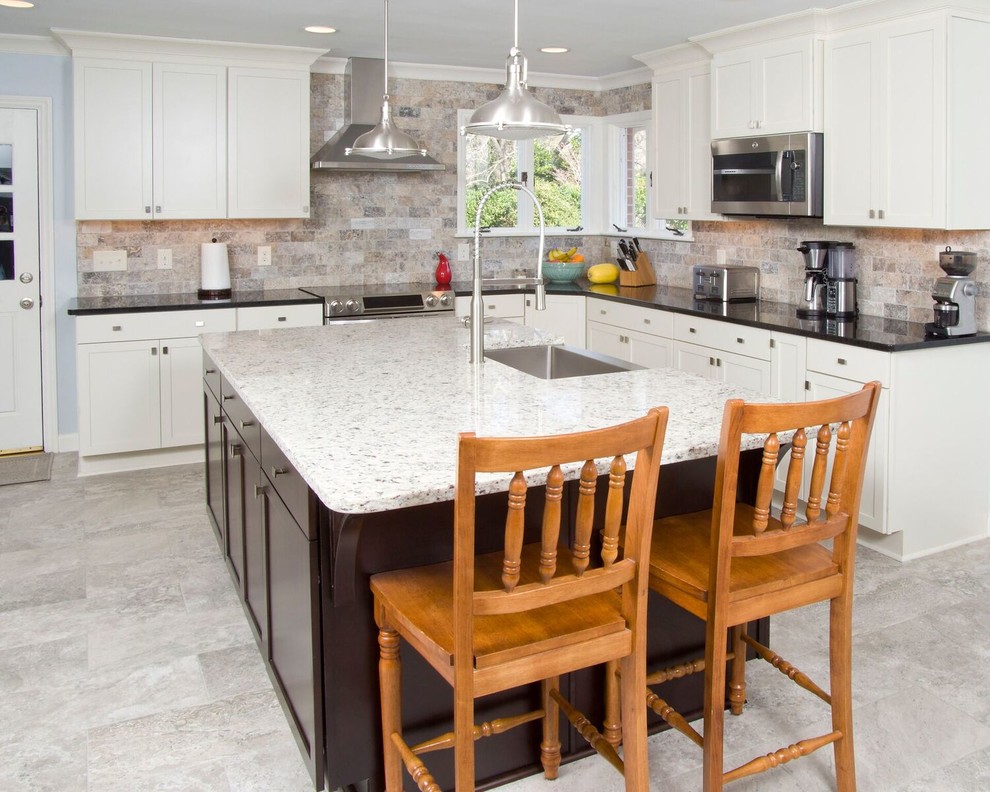 Inspiration for a large transitional u-shaped ceramic tile and gray floor eat-in kitchen remodel with a farmhouse sink, white cabinets, granite countertops, stainless steel appliances, an island, multicolored backsplash, subway tile backsplash and shaker cabinets