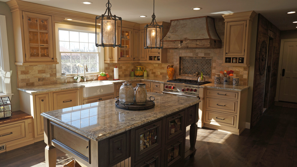 Inspiration for a mid-sized country l-shaped open plan kitchen in Philadelphia with a farmhouse sink, raised-panel cabinets, distressed cabinets, granite benchtops, beige splashback, stone tile splashback, panelled appliances, dark hardwood floors and with island.