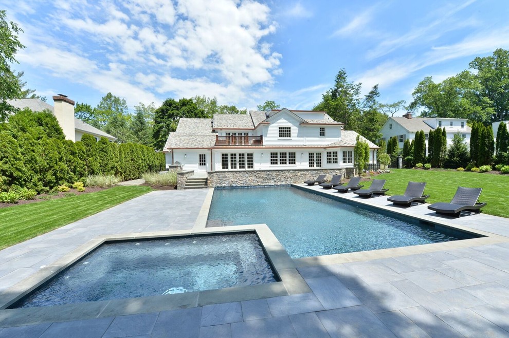 Hot tub - large transitional backyard stone and rectangular lap hot tub idea in New York