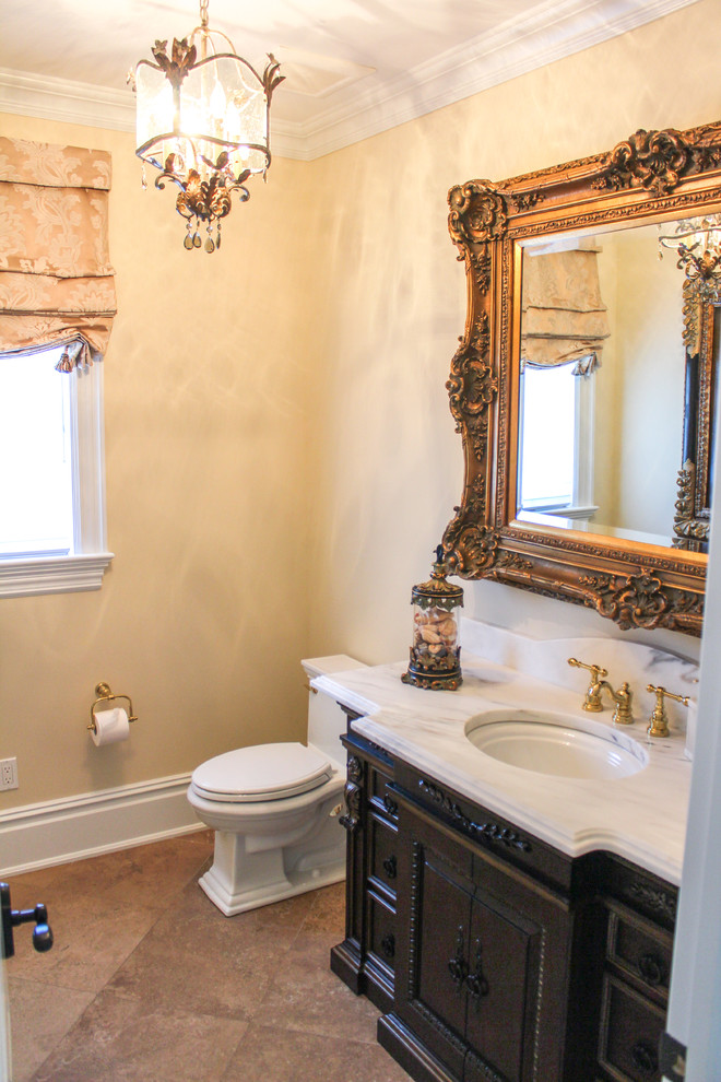 Design ideas for a mid-sized traditional 3/4 bathroom in New York with dark wood cabinets, beige tile, ceramic tile, beige walls, ceramic floors, marble benchtops, raised-panel cabinets, a two-piece toilet and an undermount sink.