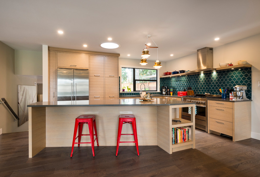 Mid-sized contemporary l-shaped kitchen in Vancouver with flat-panel cabinets, light wood cabinets, quartz benchtops, green splashback, stainless steel appliances, with island and dark hardwood floors.