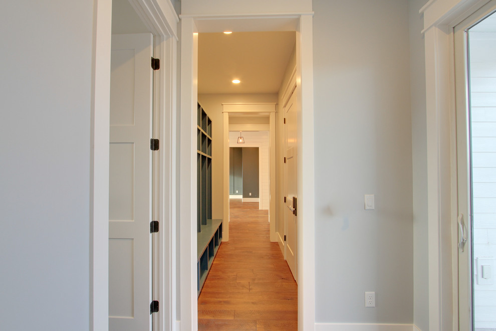 Photo of a small country mudroom in Salt Lake City with light hardwood floors.
