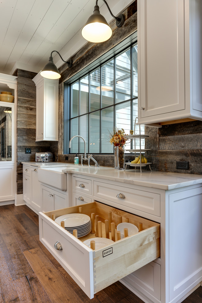 Inspiration for a large country u-shaped open plan kitchen in Raleigh with a farmhouse sink, beaded inset cabinets, white cabinets, quartz benchtops, brown splashback, panelled appliances, medium hardwood floors, with island, brown floor and white benchtop.