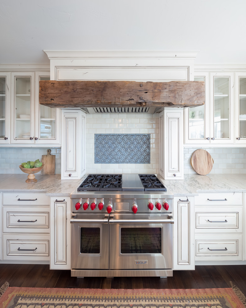 Kitchen - large transitional u-shaped kitchen idea in Denver with raised-panel cabinets, distressed cabinets, quartzite countertops and stainless steel appliances