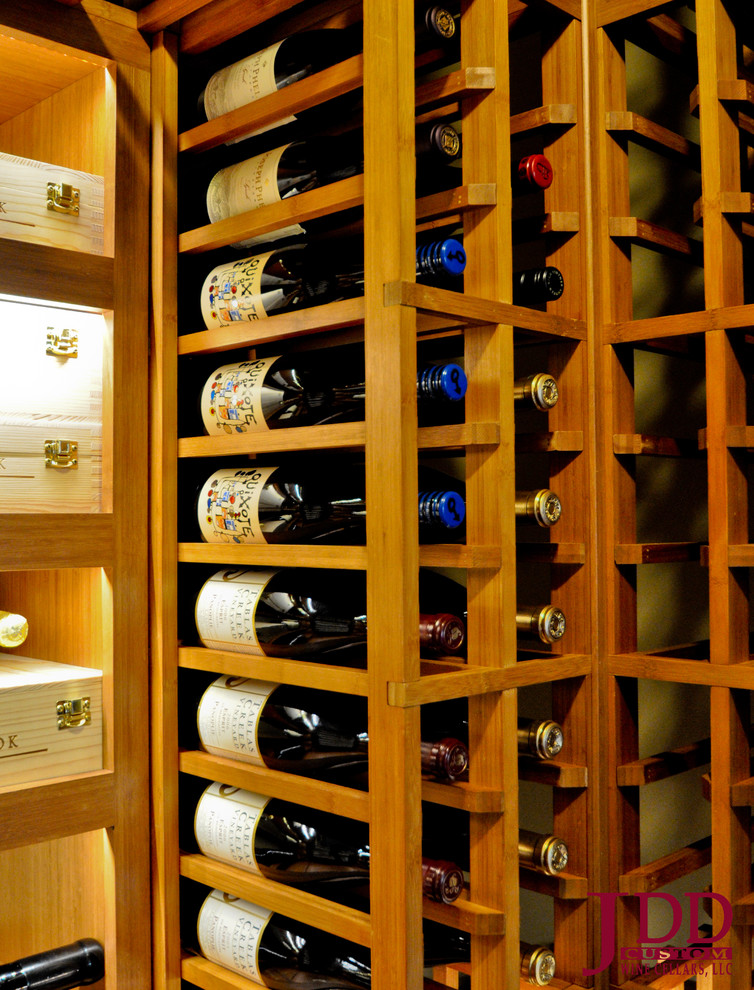Inspiration for a mid-sized traditional wine cellar in San Diego with light hardwood floors and storage racks.