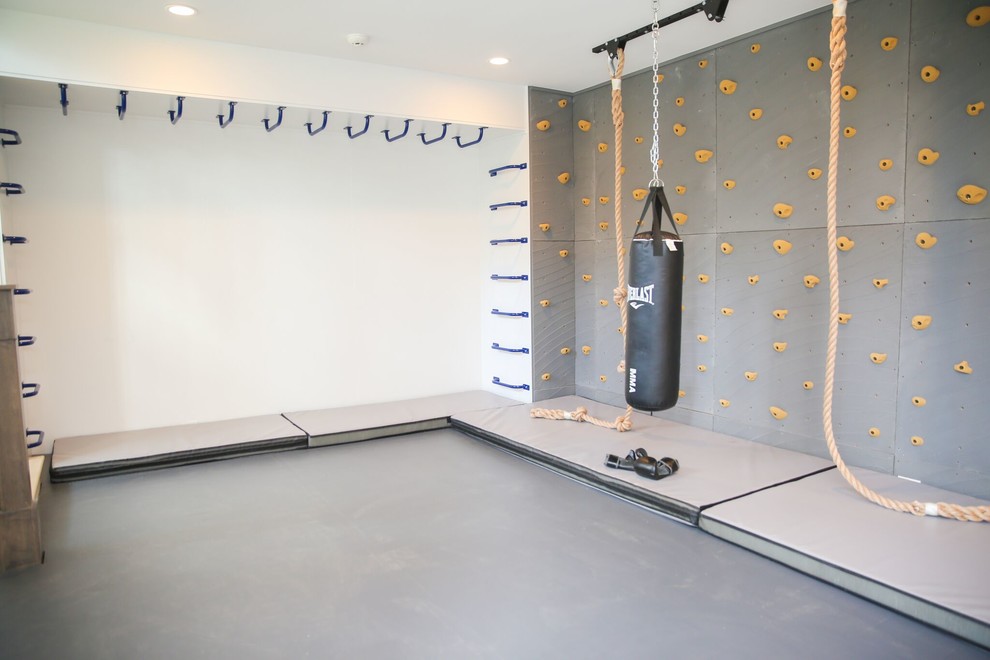 Inspiration for a mid-sized modern home gym in New York with grey walls.