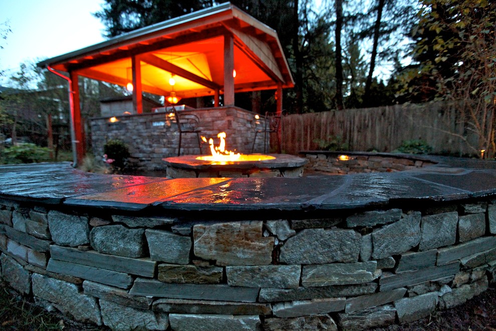 Inspiration for a large traditional backyard patio in Seattle with an outdoor kitchen, natural stone pavers and a gazebo/cabana.